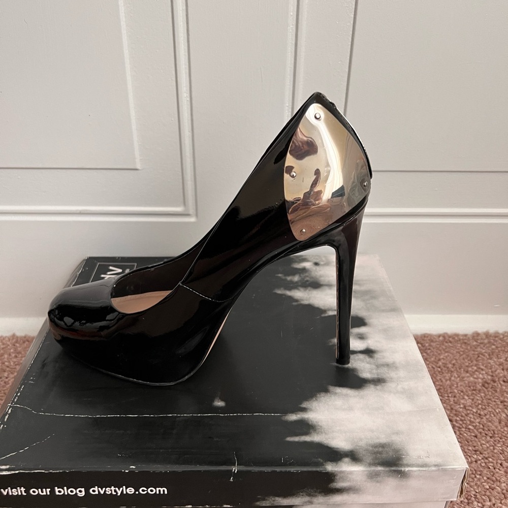 Black patent platform heels by Dolce Vita; metal details; size  9